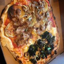 Pictured is one of our vegan pizzas: half funghi formaggi half salsiccia patate Pictured is one of our vegan pizzas: half funghi formaggi half salsiccia patate